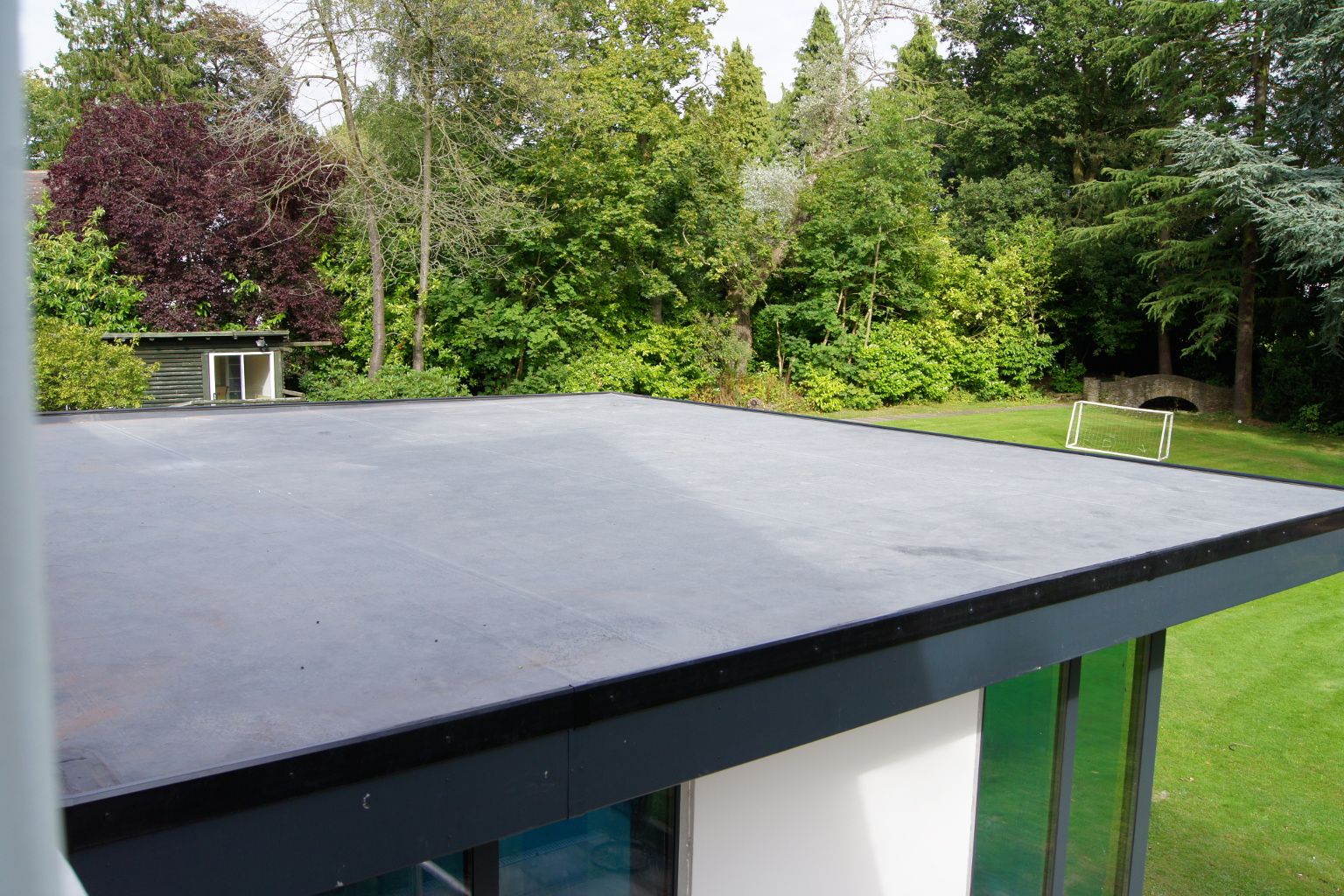 EPDM ONE self-adhesive membrane being installed on a flat roof